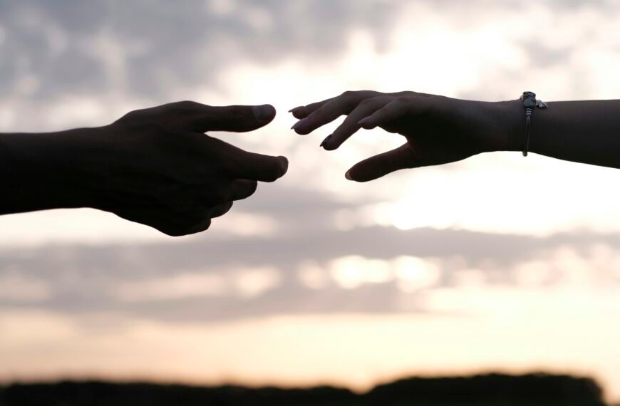 persons hand with heart shaped sign